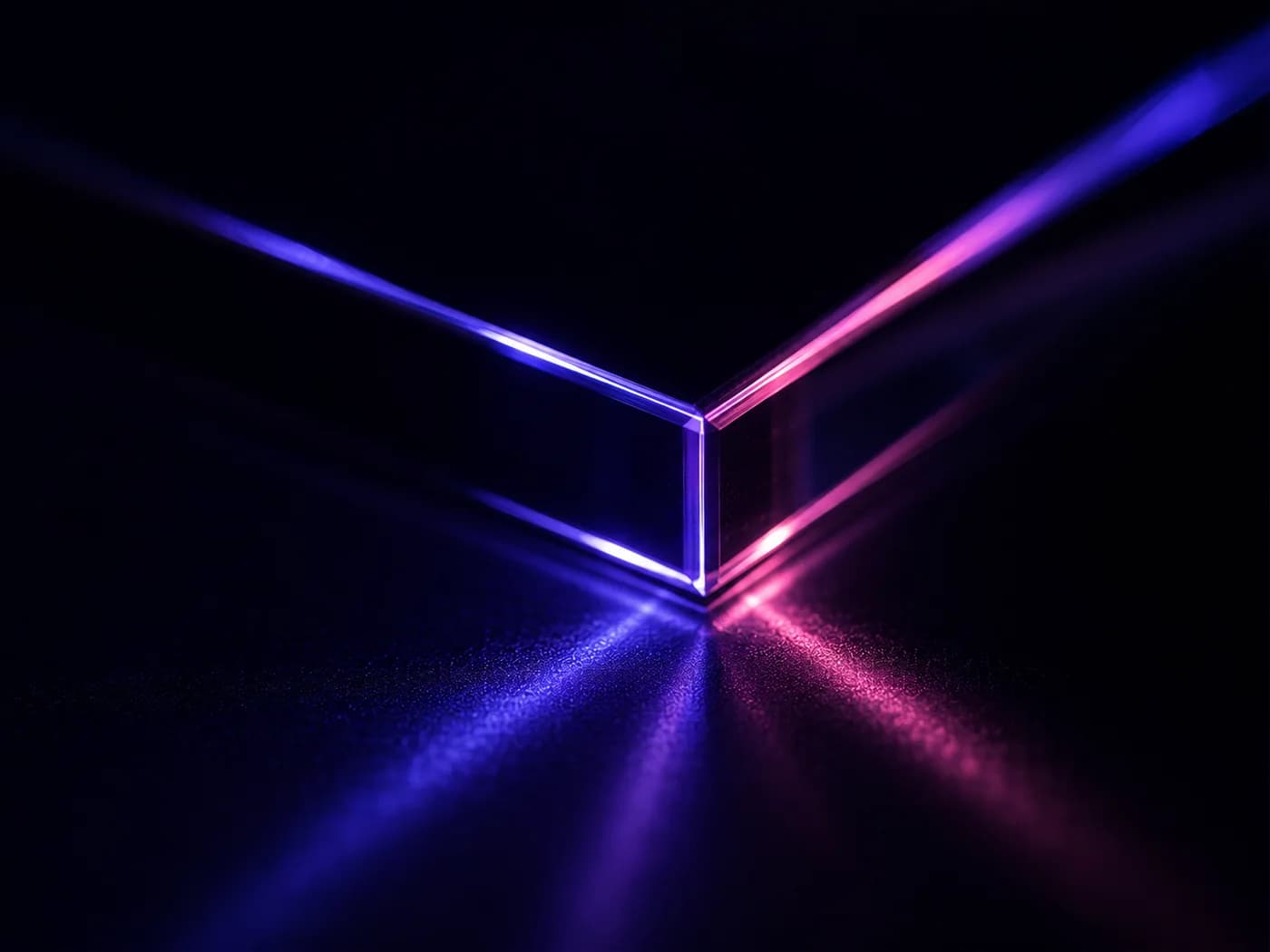 Macro detail of light refracting through the edge of dark glass